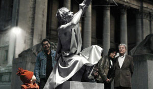 Menschen bewundern eine mit weißem Licht beleuchtete Statue